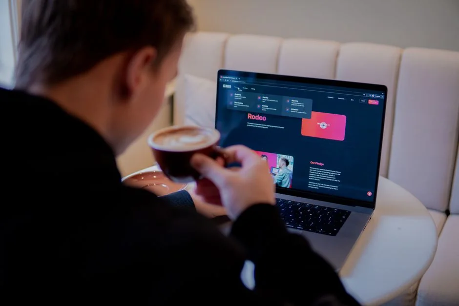 Stylish and efficient workspace with multiple monitors, laptop, and smartphone, showcasing a web design project.